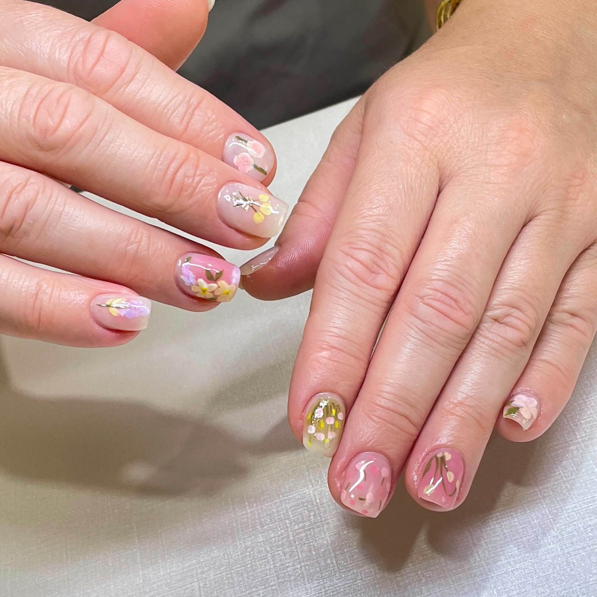 Short nails with detailed hand-painted floral artwork
