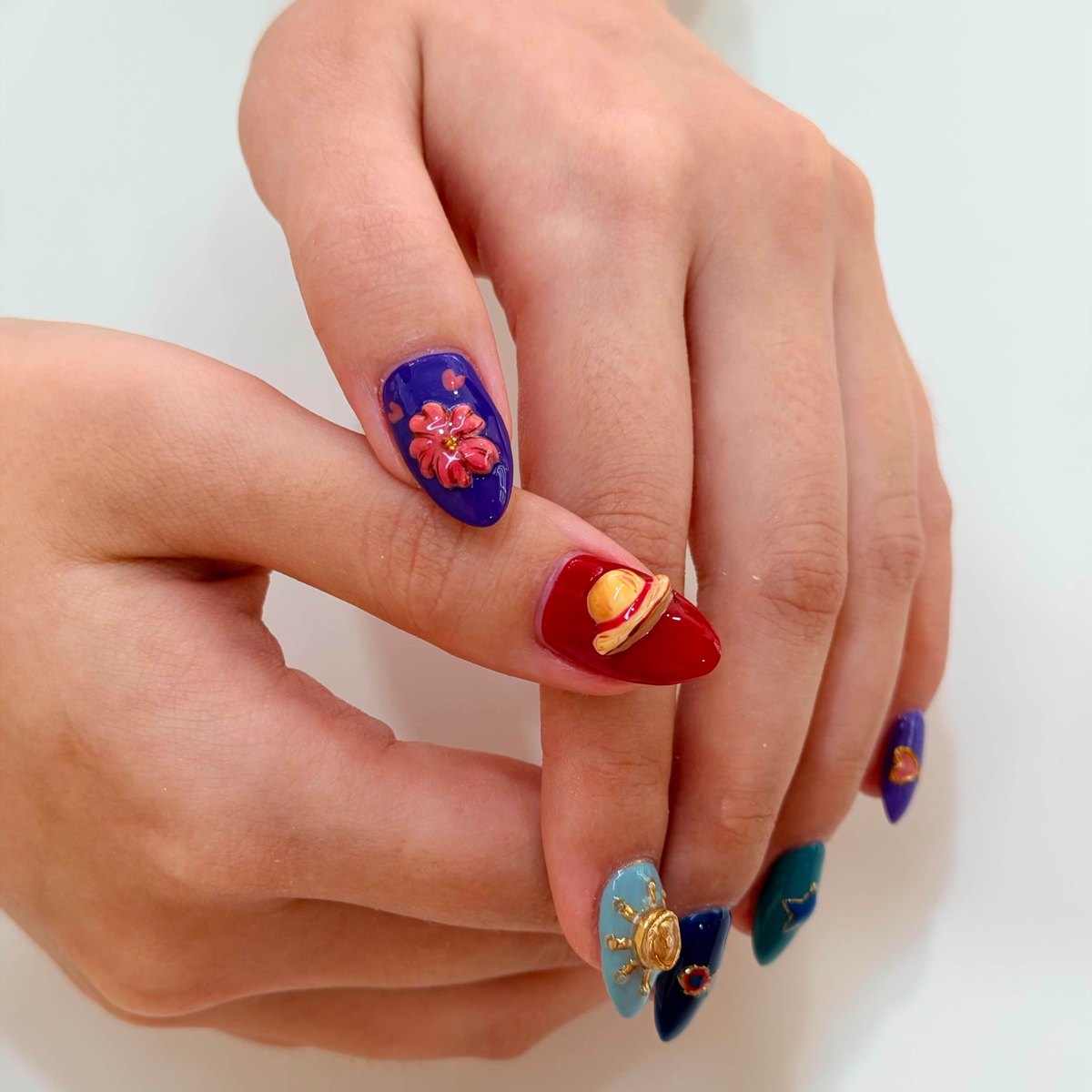 Colourful sculpted character nail art with three-dimensional details