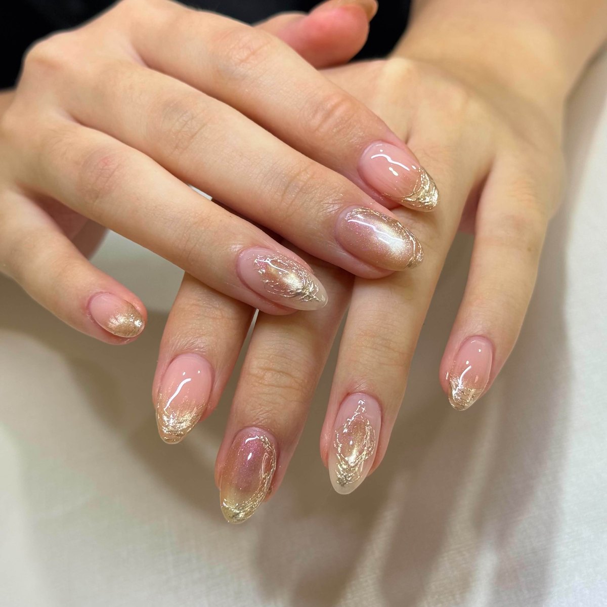 Champagne gold manicure with shimmer and elegant line accents