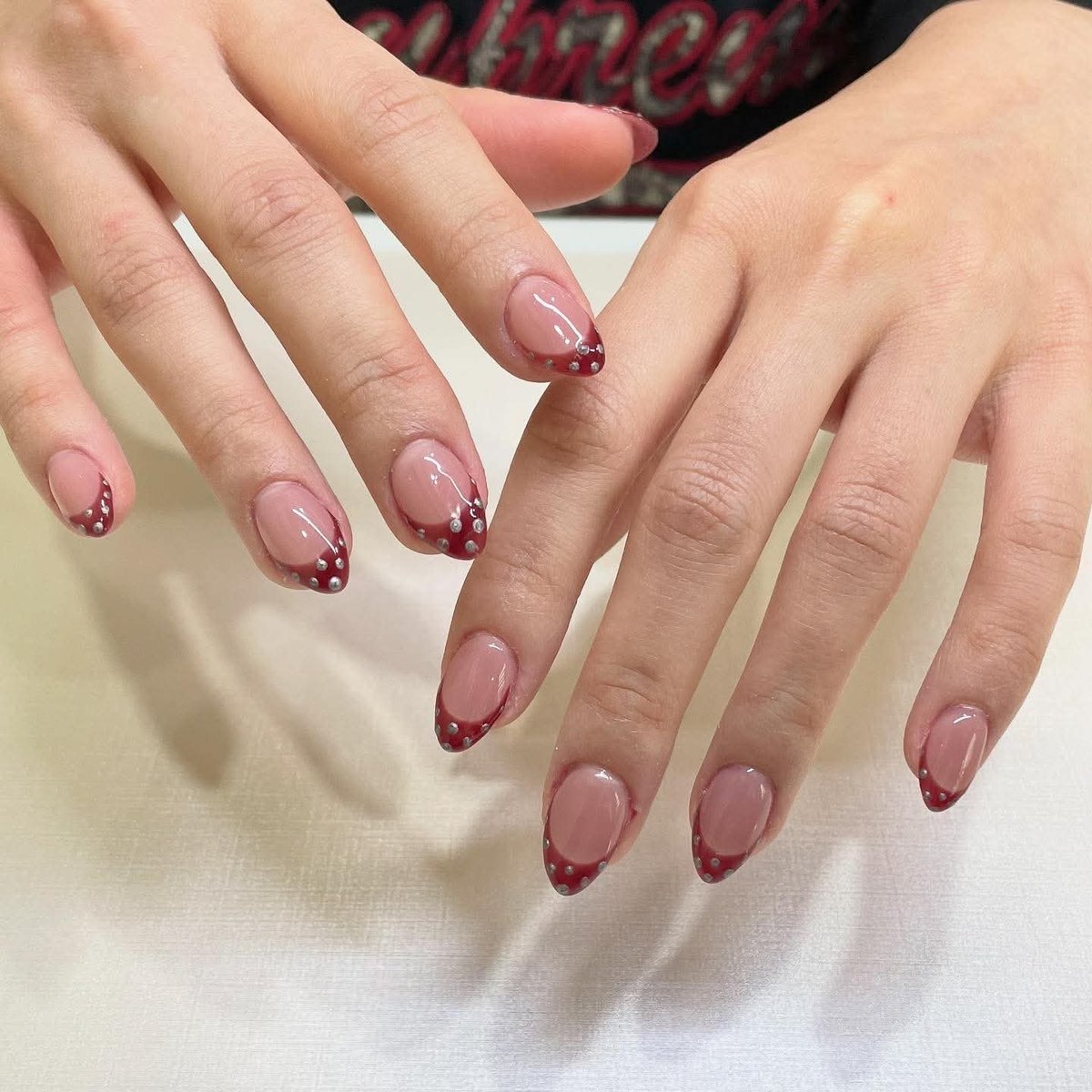 Burgundy French tips finished with crystal accents